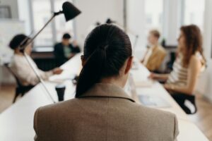 woman in brown coat sitting on chair