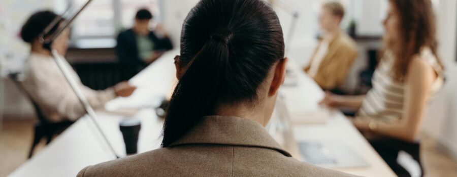 woman in brown coat sitting on chair